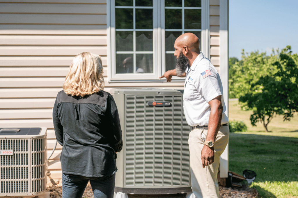 Wisler AC technician showing customer her new AC installation.